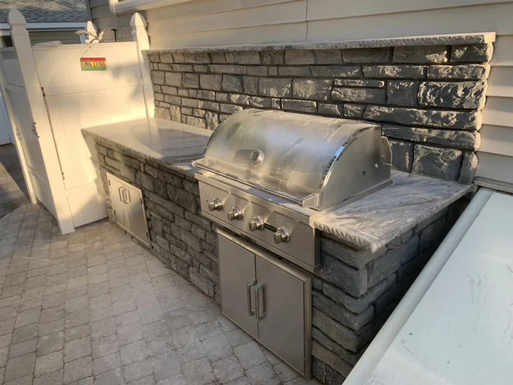 Pre-fabricated outdoor kitchen integrated into a compact backyard, illustrating convenience and functionality