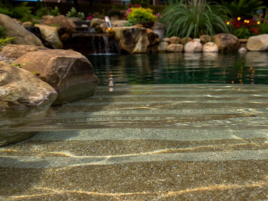Purification begins beneath the surface, not at the pool wall. Water circulates through the pool